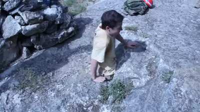Guy passes through a small entry to explore a cave