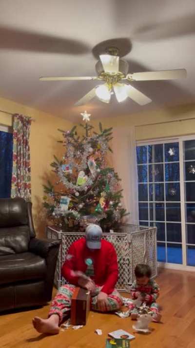 Showing my son how to open a present