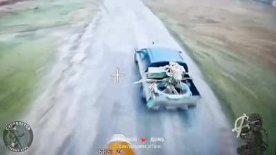 Antagonist's Group Fiber-Optics FPV drone strike on a Ukrainian pickup carrying ammo and a soldier in the back