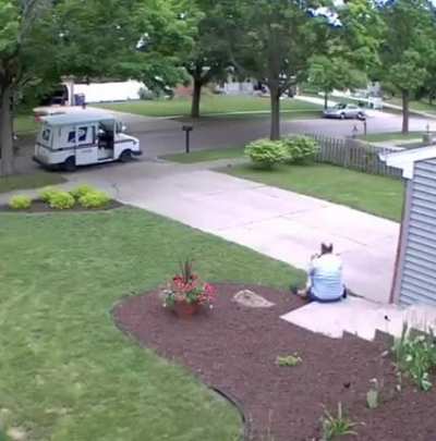 This USPS driver takes a break with a good boy