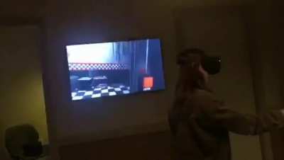 My sister playing Five Nights at Freddy's VR. I told her to look around the corner and she got jumpscared 😈😈😆