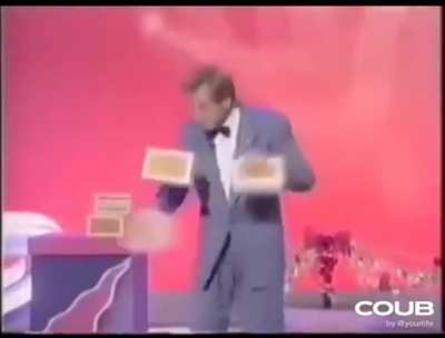 Magician juggling boxes giving the illusion of having 3 hands