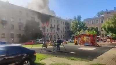 These russians are normally watching a building burnin' .