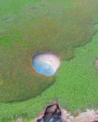This is a hidden beach in the Merietas Islands, apparently it was created by a bomb because the islands were used by the military.