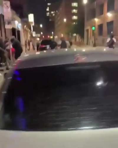 Sidewalk brawl with top-notch commentary from behind the camera