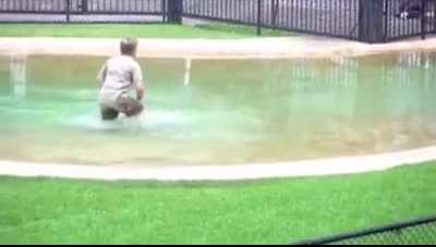 Robert Irwin, wearing his Dads shoes, Asking Mum if he can get in the water...