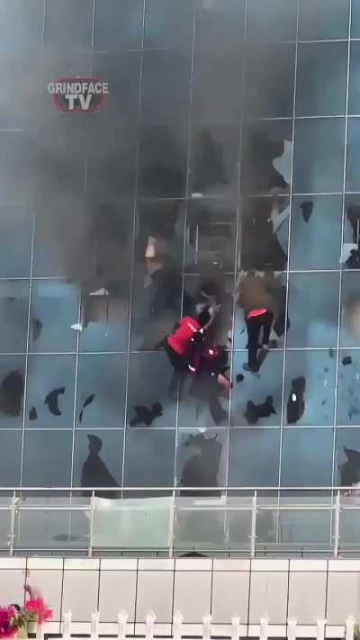 People escaping fire through windows