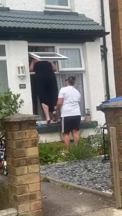 British woman gets stuck in a window. Positive freakout ensues. 