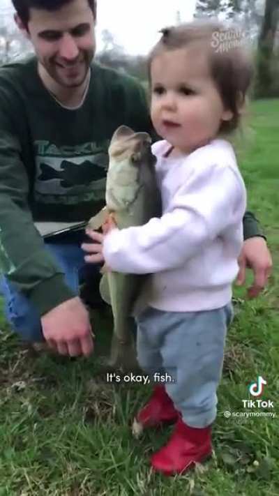 Little girl tells a fish it’s okay while it’s suffocating