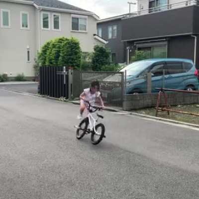 There's no training wheels on her bike