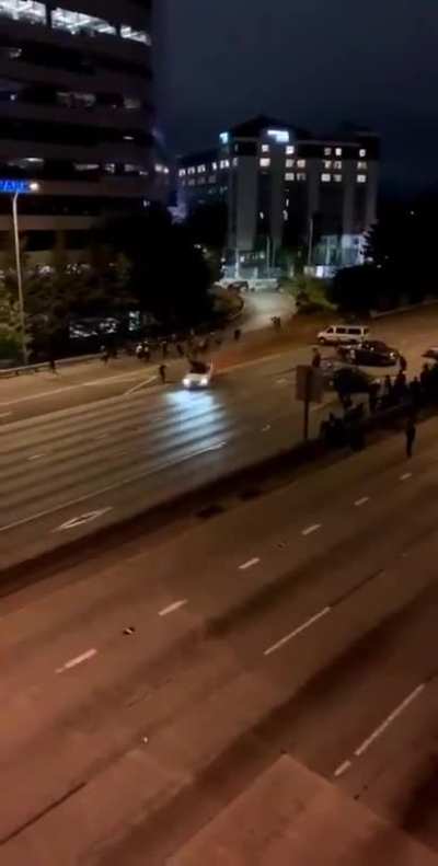Two Seattle protestors getting run over by a car on the highway