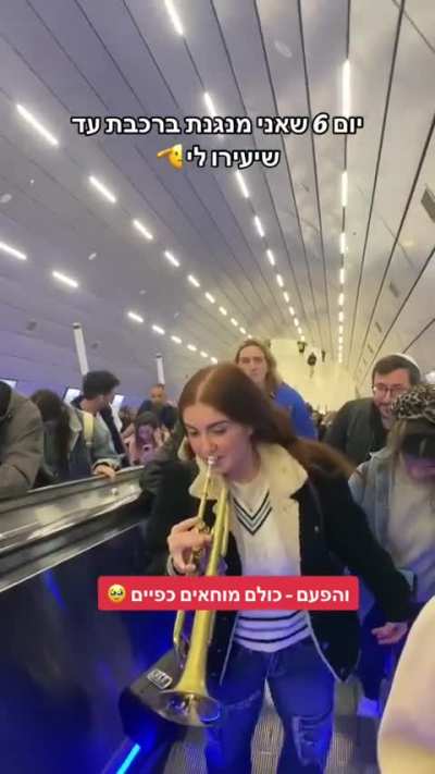 The headline in the video says: "Sixth day I'm playing trumpet at the train station until someone tells me to stop."