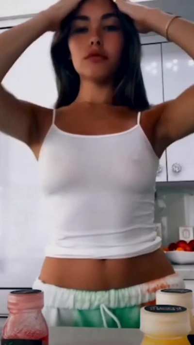 Braless Madison wants us to stare at her pokies as she moves her hair out of the way
