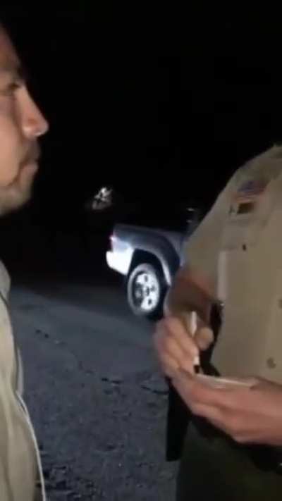 Police officer detains and arrest a guy for wearing a hoodie.