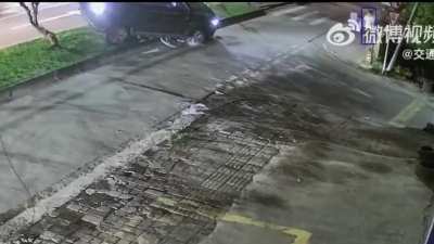 Survived by a rock, man crawls out from under the car.