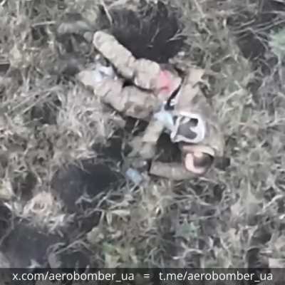 A russian invader was hit by a drone-dropped grenade and then proceeded to kill himself by stabbing a knife into his chest. Video by the Ukrainian 30th Mechanized Brigade 