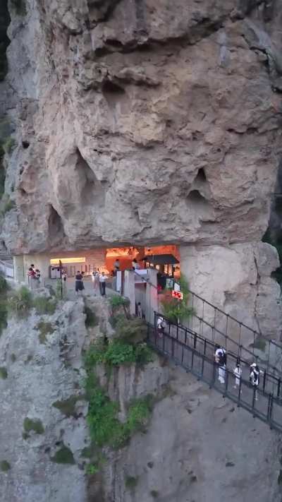 In China many natural beauties are located in the isolated countryside, where local people face poverty due to lack job or opportunities, so they build touristic attractions, like this cafe in the middle of a mountain trail to attract revenue and creat jo