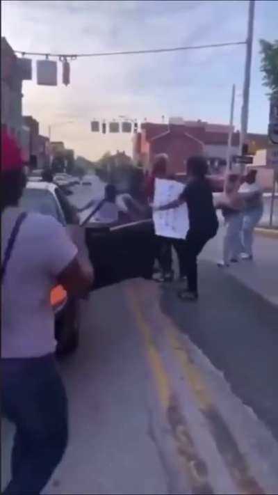 White man leaves his car while faced with a road block, and gets beaten by violent mob of black people.