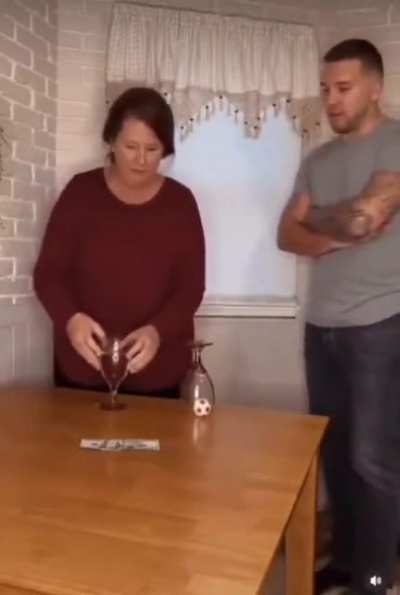 The son challenged his mother (a physics teacher) to move the ball from the upside down glass to the other without touching the ball.