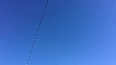 a wire and a road sign in the blue sky (Leninskiy Prospect, Saint Petersburg, RU)