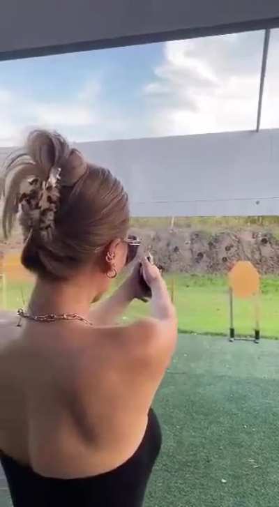 WCGW touching the barrel of a gun at a shooting range