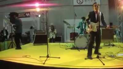 Bassist makes sweet jump, kicks shoe into crowd, crowd politely returns shoe, concert continues without incident.