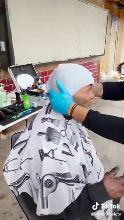 Giving a haircut to a homeless person