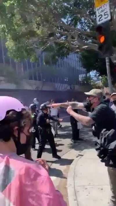 Cop shoots protester with a rubber bullet after she asked them to put the guns down