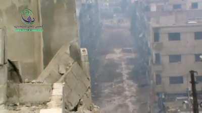 Opposition cameraman is almost killed by incoming sniper fire while exposing himself to film - Daraya - 2014