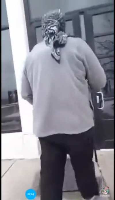Man walks into police station, wearing a mask, and carrying an assault rifle.