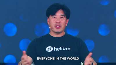 Frank Mong on the stage at Token2049 Singapore explaining how Helium is making service affordable