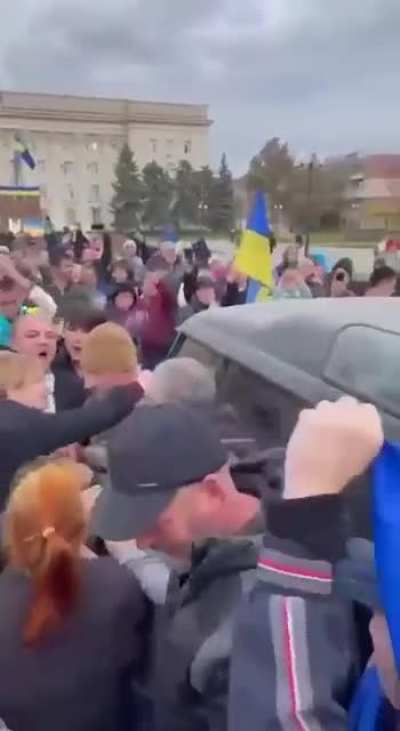 Ukrainian soldiers being celebrated in the centre of Kherson after recently retaking the city.