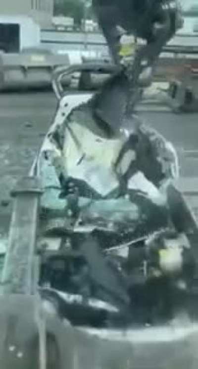 Destroying cars with giant metal claw.