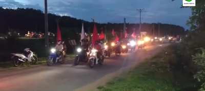 Protestors against the military coup in Myanmar rally with a scooter march