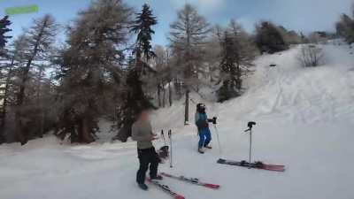 Drone almost crashes into guy skiing