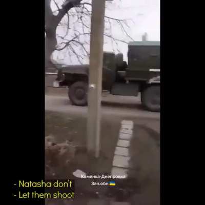 Defiant Ukrainian woman recording ruzzian convoy going through Kam'yanka-Dniprovs'ka, Zaporizhia Oblast. When confronted she replies" Here in Ukraine filming is not prohibited ... Your going to shoot a woman?? then shoot"