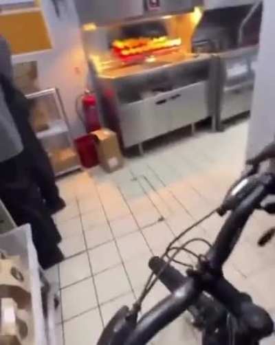 Man goes for a bike ride in McDonalds