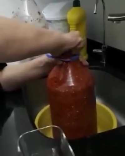 Opening a bottle of tomato sauce