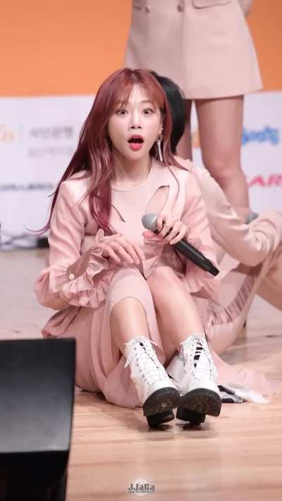 JiU being surprised after accidentally hitting her mic on the stage