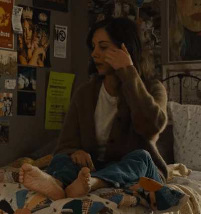 Pouting on her bed (from "Somebody I Used to Know")