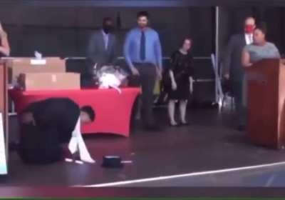 This guy is too overwhelmed at his graduation ceremony...