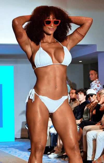 Flexing her pecs on the catwalk