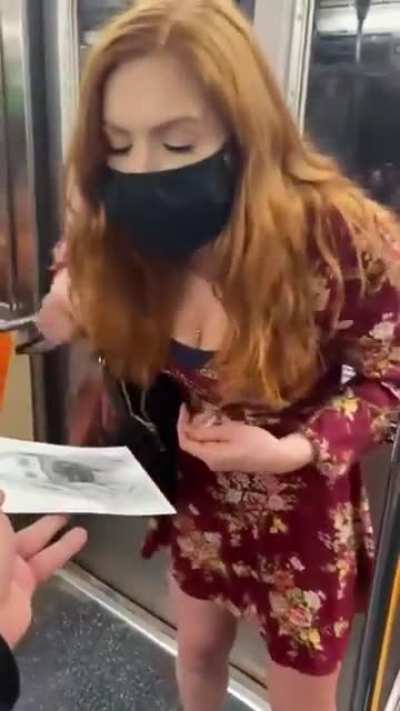 Artist draws a portrait of a woman in nyc subway