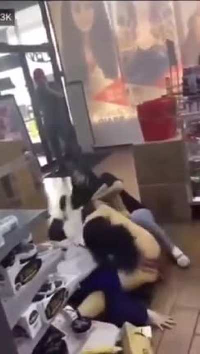 Lady hits customer that stole something with a shopping basket