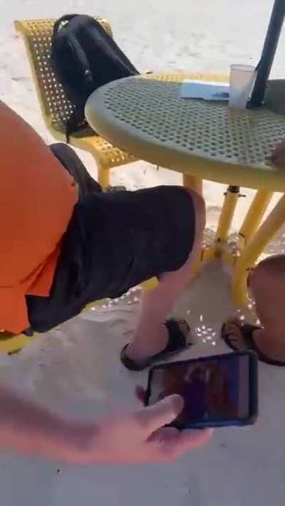 girl catches old man taking photos of young girls (presumably minors) on the beach in florida
