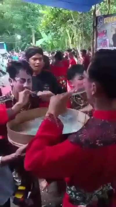Possessed Javanese dancer eating broken glasses