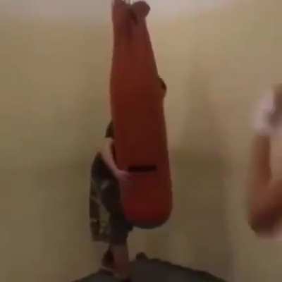 Standing behind punching bag
