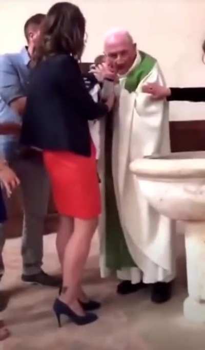 Priest slaps a baby in front of parents