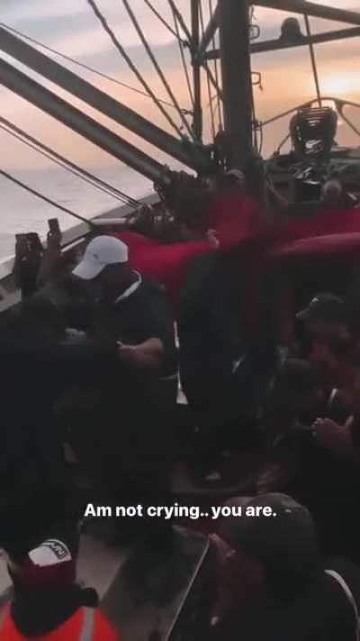 Moroccan fishermen celebrating their country's qualification to the Semi-final.