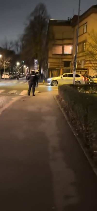 Protester running and filming out of shape Serbian cops while they are trash talking each other.